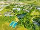 Aerial view showing community amenities such as pool, tennis courts, and pond at 9942 Linksland Dr, Huntersville, NC 28078