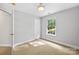 Well-lit bedroom featuring neutral walls and carpet flooring at 9942 Linksland Dr, Huntersville, NC 28078