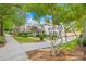 Two story house with a tree lined street and manicured lawn at 9942 Linksland Dr, Huntersville, NC 28078