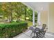 Small front porch with two chairs and a table, overlooking a landscaped yard at 9942 Linksland Dr, Huntersville, NC 28078