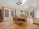 Spacious dining room with hardwood floors and a beautiful chandelier at 316 W Kingston Ave, Charlotte, NC 28203