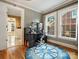 Home office with hardwood floors, built-in shelving, and nautical rug at 316 W Kingston Ave, Charlotte, NC 28203