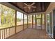 Relaxing screened porch with wooden deck and ceiling fan at 0001 Bolton Rd, Catawba, NC 28609