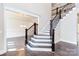 Elegant, two-story staircase with dark wood and wrought iron accents at 0001 Bolton Rd, Catawba, NC 28609