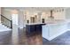 Modern kitchen with white cabinets, large island, and dark hardwood floors at 0001 Bolton Rd, Catawba, NC 28609