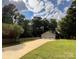 Triple-car garage with a long driveway and fenced yard at 142 Scotland Dr, Mooresville, NC 28115