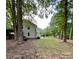 House backyard, large trees, and a grill at 142 Scotland Dr, Mooresville, NC 28115