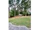 Landscaped backyard with shed and mature trees at 142 Scotland Dr, Mooresville, NC 28115
