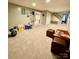 Finished basement with neutral carpeting and lots of storage at 142 Scotland Dr, Mooresville, NC 28115