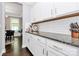 White cabinets, granite countertops, and a view into the dining area at 117 Tomahawk Dr, Mooresville, NC 28117