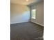 Bright bedroom with neutral carpeting and a window at 119 Kerr Walk Dr # 36, Statesville, NC 28677