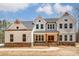 Two-story farmhouse style home with stone accents and a welcoming front porch at 0002 Bolton Rd, Catawba, NC 28609