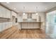 Modern kitchen with white cabinetry, granite countertops, and large island at 0002 Bolton Rd, Catawba, NC 28609