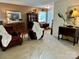 Living room with two leather chairs, a wood table and window at 6132 Heath Ridge Ct, Charlotte, NC 28210