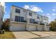 Rear view of townhouses showcasing garages and balconies at 647 District Ct # 15, Fort Mill, SC 29708