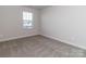 Empty bedroom featuring carpet flooring and large windows with blinds at 1529 Harper Landing Blvd # 197, Stanley, NC 28164