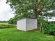 Small white shed nestled under a large tree at 8909 Highway 218 Hwy, Marshville, NC 28103