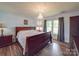 Spacious main bedroom with hardwood floors and large window at 8909 Highway 218 Hwy, Marshville, NC 28103