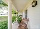 Inviting front porch with rocking chair and potted plants at 8909 Highway 218 Hwy, Marshville, NC 28103