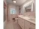Bathroom features a double vanity, pink tile, and updated fixtures at 8909 Highway 218 Hwy, Marshville, NC 28103
