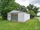 White metal outbuilding with roll-up door at 8909 Highway 218 Hwy, Marshville, NC 28103