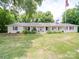 Ranch-style home with a metal roof and front porch at 8909 Highway 218 Hwy, Marshville, NC 28103