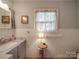Small bathroom with updated vanity and a window at 8909 Highway 218 Hwy, Marshville, NC 28103