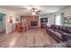 Spacious living room with hardwood floors, fireplace, and leather furniture at 8909 Highway 218 Hwy, Marshville, NC 28103