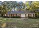Brick ranch house with a light green door and landscaping at 201/215 Smithfield Dr, Charlotte, NC 28270