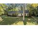 Brick ranch house with mature landscaping and a spacious lawn at 201/215 Smithfield Dr, Charlotte, NC 28270