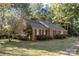 Brick ranch house with mature landscaping and a brick walkway at 201/215 Smithfield Dr, Charlotte, NC 28270