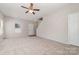 Spacious living room with neutral carpeting and ceiling fan at 4803 Roxfield Ln, Charlotte, NC 28215