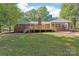 Brick house with a large deck and sunroom at 2200 Quail Nw Dr, Concord, NC 28027