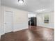 Open dining area with dark wood floors and kitchen views at 109 W Shannonhouse St, Shelby, NC 28152