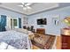 Main bedroom with hardwood floors, sitting area and a large TV at 1375 Valhalla Dr, Denver, NC 28037