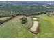 Aerial view of property featuring a pond and lush greenery at 8510 Olive Branch Rd, Marshville, NC 28103