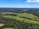 Expansive aerial view of a rural property with fields at 8510 Olive Branch Rd, Marshville, NC 28103