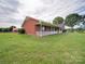 Side view of brick ranch house with a covered porch at 8510 Olive Branch Rd, Marshville, NC 28103