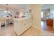 Bright kitchen features white cabinets, tile flooring, and a breakfast bar at 8510 Olive Branch Rd, Marshville, NC 28103