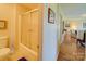 Neat bathroom with a toilet, shower, and a view to living room at 8510 Olive Branch Rd, Marshville, NC 28103