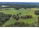 Aerial view of a large property with fields and trees at 8510 Olive Branch Rd, Marshville, NC 28103