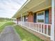 Front porch detail of brick ranch house with white railings at 8510 Olive Branch Rd, Marshville, NC 28103