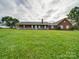 Brick ranch house on a large grassy lot, showcasing a front porch at 8510 Olive Branch Rd, Marshville, NC 28103