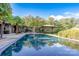 Stunning pool with reflection of the home and lush greenery at 501 Journey Sw St, Concord, NC 28025