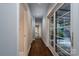 Long hallway with hardwood floors and access to backyard at 501 Journey Sw St, Concord, NC 28025