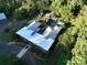 Aerial view of L-shaped home with pool and lush landscaping at 501 Journey Sw St, Concord, NC 28025