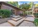 Landscaped backyard with concrete stairs leading to patio and lush greenery at 501 Journey Sw St, Concord, NC 28025