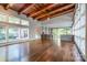 Open living area with hardwood floors, wood beams, and large windows at 501 Journey Sw St, Concord, NC 28025