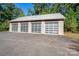 Four-car garage with frosted glass doors and large driveway at 501 Journey Sw St, Concord, NC 28025