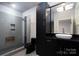 Modern bathroom with a large walk-in shower, dark vanity, and updated fixtures at 501 Journey Sw St, Concord, NC 28025